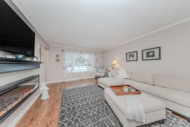 living room with ornamental molding and hardwood / wood-style floors