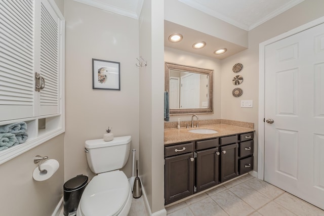 bathroom featuring crown molding, vanity, tile patterned floors, and toilet