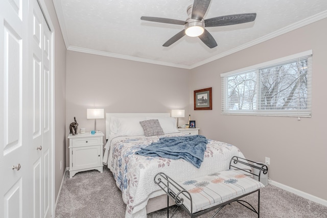 bedroom with ornamental molding, ceiling fan, light carpet, a textured ceiling, and a closet