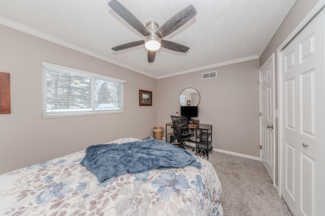 carpeted bedroom featuring crown molding, ceiling fan, and a textured ceiling