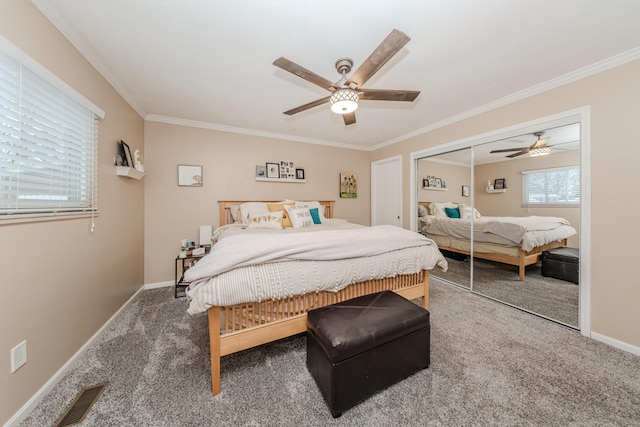 bedroom with ornamental molding, a closet, ceiling fan, and carpet