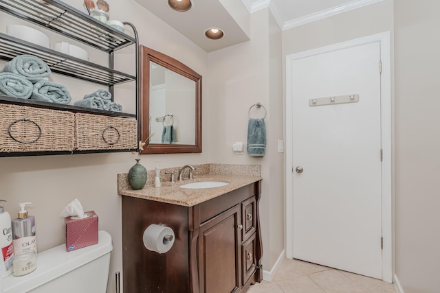 bathroom featuring tile patterned flooring, ornamental molding, vanity, and toilet