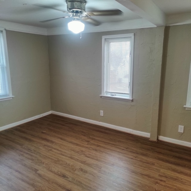 empty room with dark wood-type flooring and ceiling fan