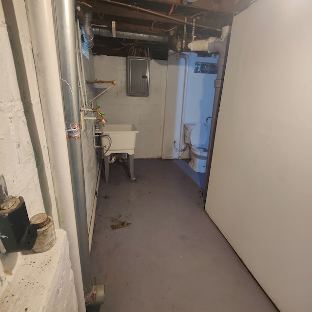 basement featuring electric panel and sink