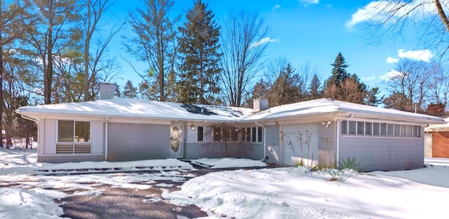 view of front of home with a garage and a chimney