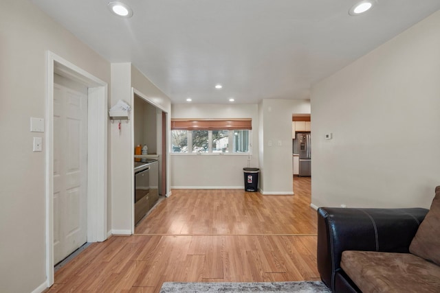 living area featuring recessed lighting, light wood-style flooring, and baseboards