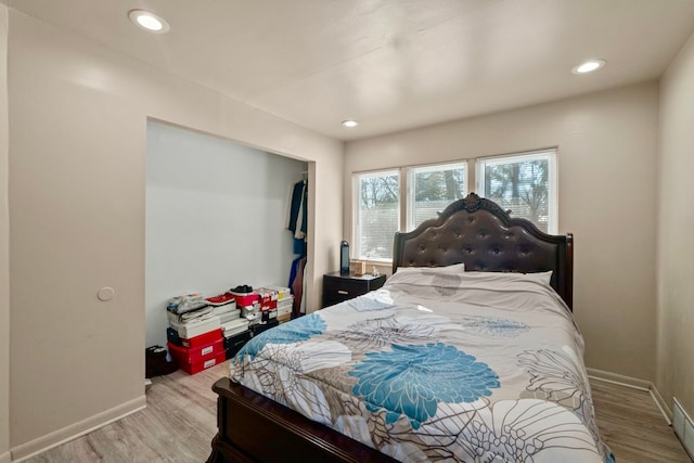 bedroom featuring light wood-type flooring, baseboards, and recessed lighting