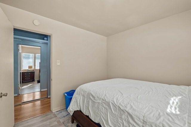 bedroom with light wood-style floors and baseboards