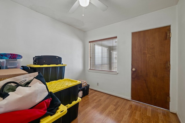 rec room featuring ceiling fan, baseboards, and wood finished floors