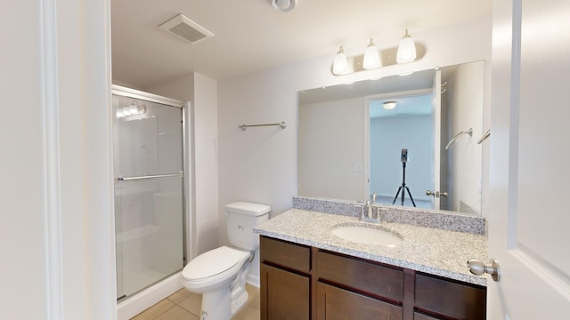 bathroom with vanity, toilet, an enclosed shower, and tile patterned flooring