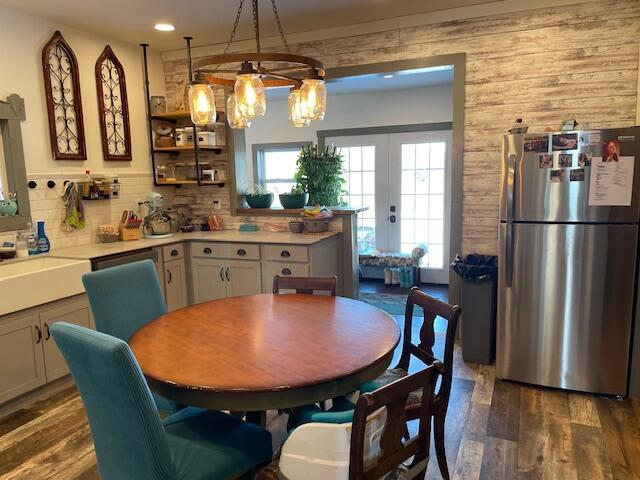 dining space featuring sink, dark wood-type flooring, and french doors