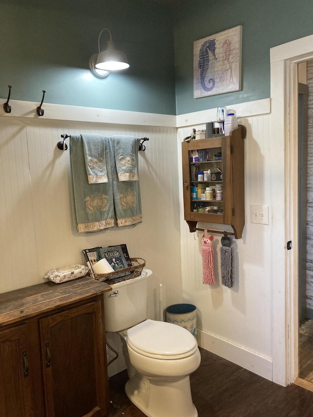 bathroom with hardwood / wood-style flooring and toilet