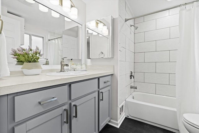 full bathroom featuring vanity, shower / bath combo, and toilet