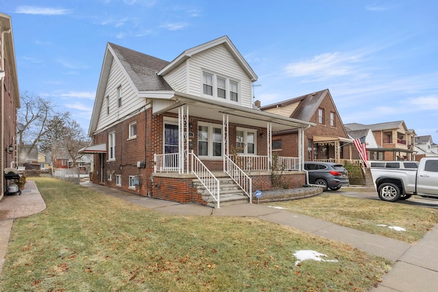 view of front of home with a porch and a front lawn