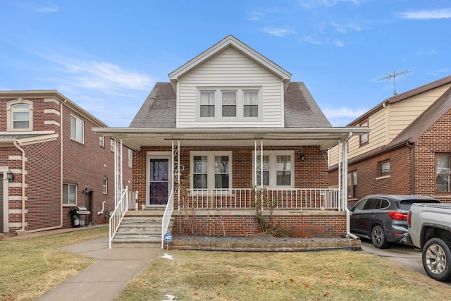 bungalow-style home with a porch and a front lawn