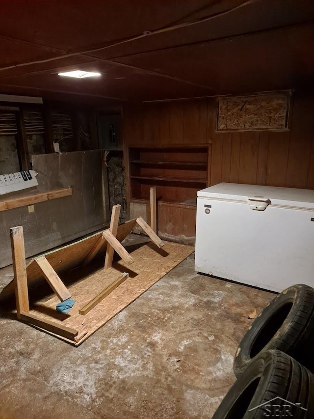 interior space with wooden walls and refrigerator