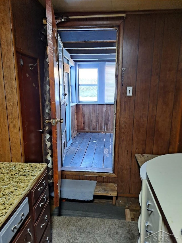 bathroom with vanity and wooden walls