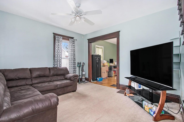 carpeted living room with ceiling fan