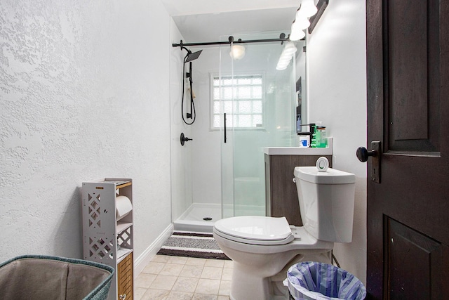 bathroom with walk in shower, tile patterned floors, vanity, and toilet