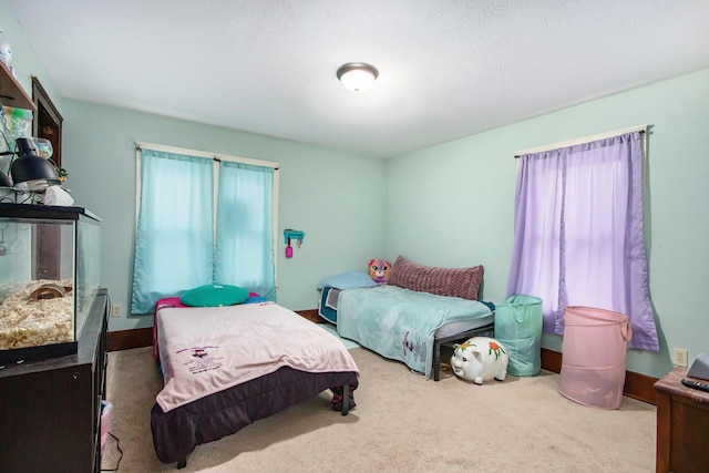 carpeted bedroom with multiple windows