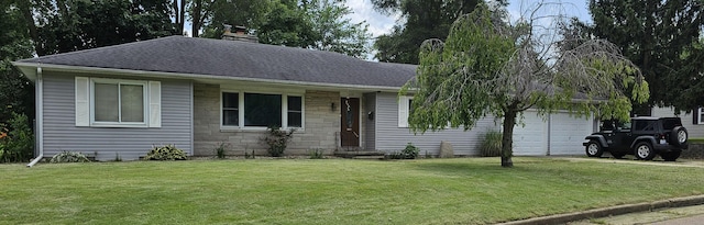 ranch-style house featuring a garage and a front lawn