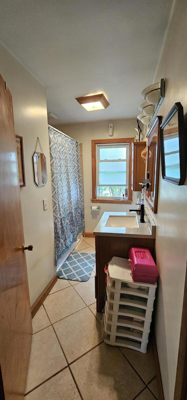 bathroom with tile patterned floors and vanity