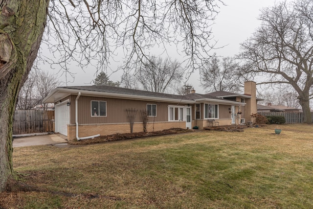 view of front of property featuring a garage and a front lawn