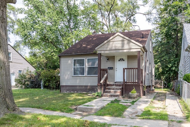 bungalow-style home with a front yard