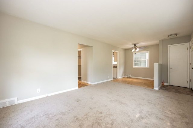 unfurnished living room with ceiling fan and light colored carpet