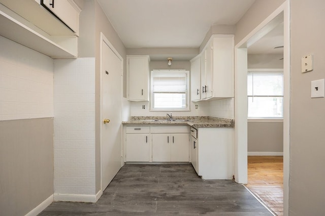 kitchen featuring white cabinetry, dark hardwood / wood-style floors, and sink