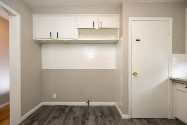 kitchen featuring dark wood-type flooring and white cabinets