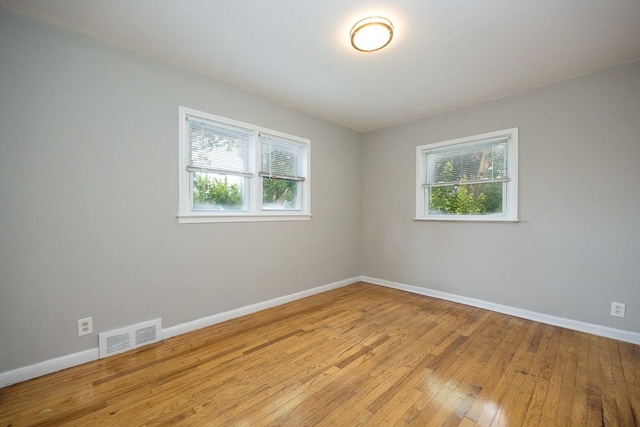 empty room featuring light hardwood / wood-style flooring and a healthy amount of sunlight