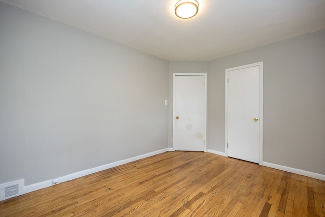 spare room with light hardwood / wood-style floors