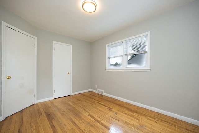 spare room featuring light hardwood / wood-style flooring