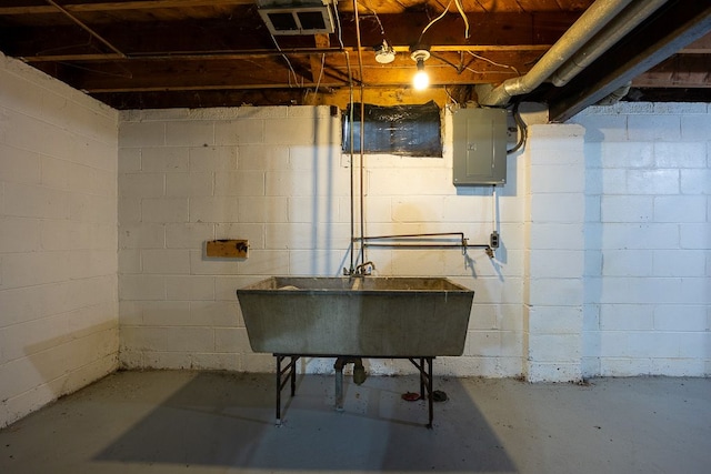 basement featuring electric panel and sink