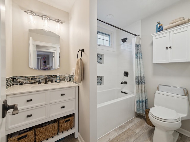 full bathroom featuring toilet, tasteful backsplash, wood-type flooring, shower / tub combo, and vanity