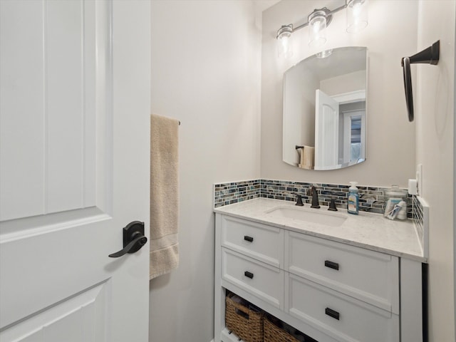 bathroom featuring vanity and decorative backsplash