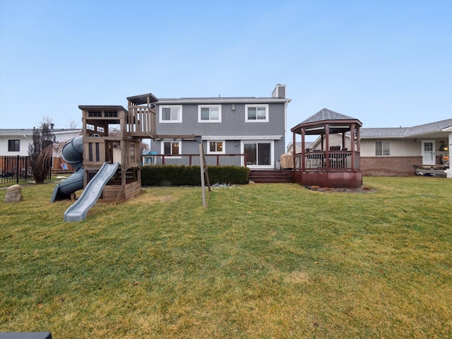 back of house with a yard, a playground, and a gazebo