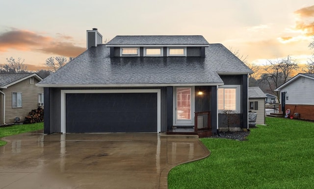 view of front facade with a garage and a yard