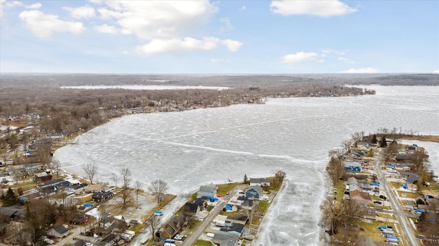 snowy aerial view with a water view