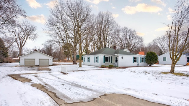 view of front of house featuring a garage and an outdoor structure