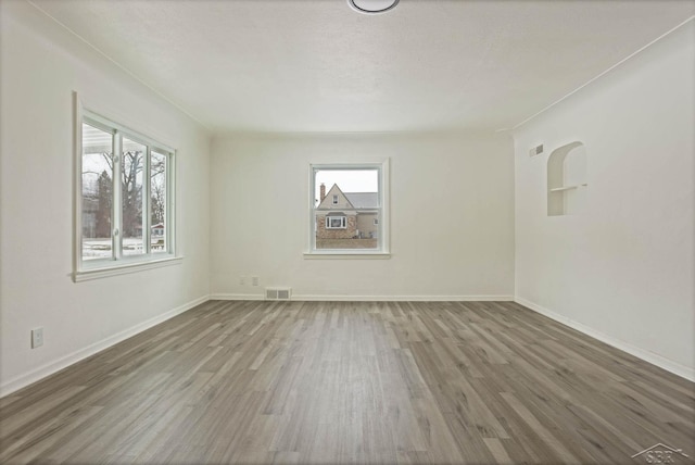 spare room featuring dark hardwood / wood-style flooring and a textured ceiling