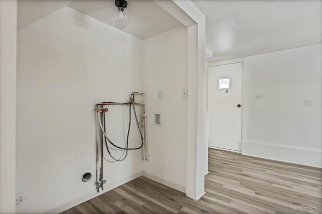 laundry area with hookup for a washing machine and light hardwood / wood-style floors