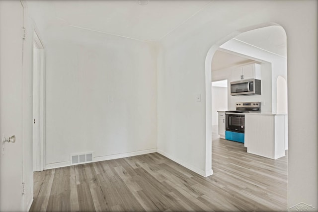 spare room featuring light hardwood / wood-style flooring