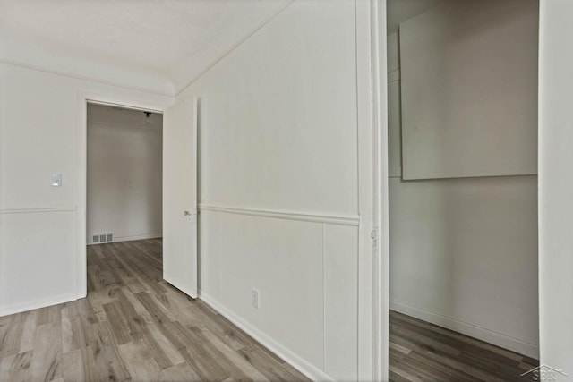 corridor with light hardwood / wood-style flooring