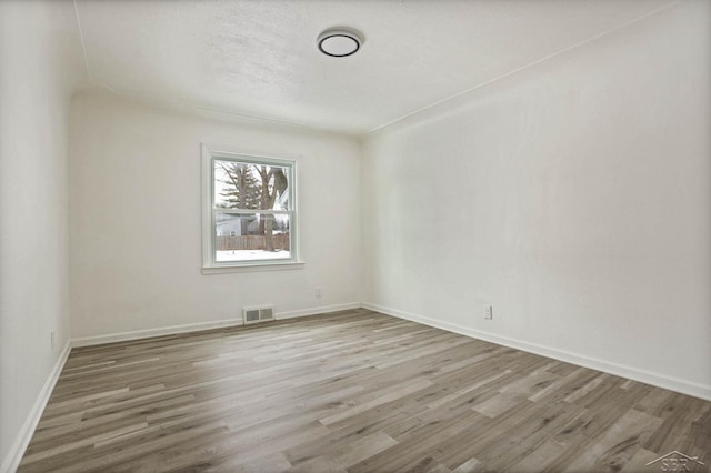 unfurnished room featuring hardwood / wood-style floors