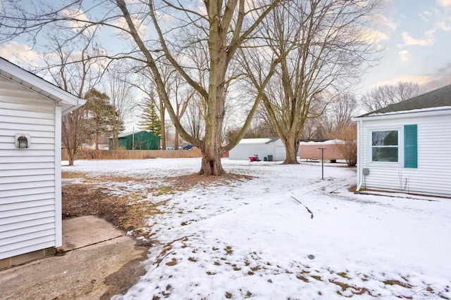 view of yard layered in snow