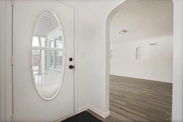 doorway with dark wood-type flooring