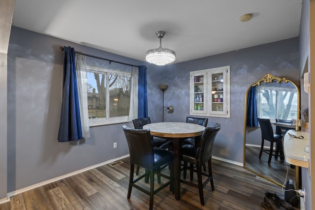 dining area featuring dark hardwood / wood-style floors