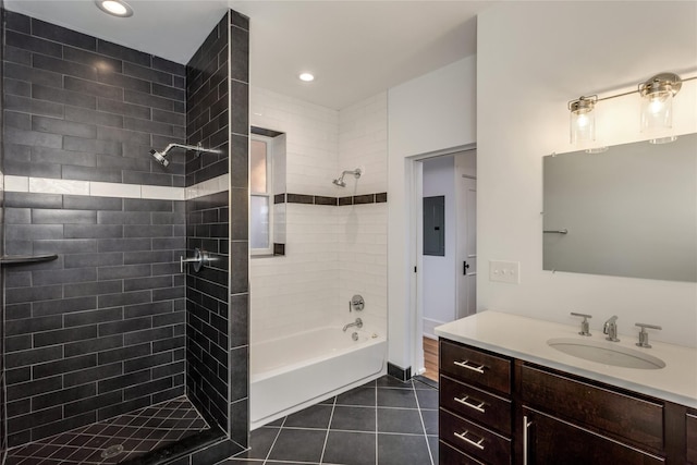 bathroom featuring tiled shower / bath combo, tile patterned floors, electric panel, and vanity